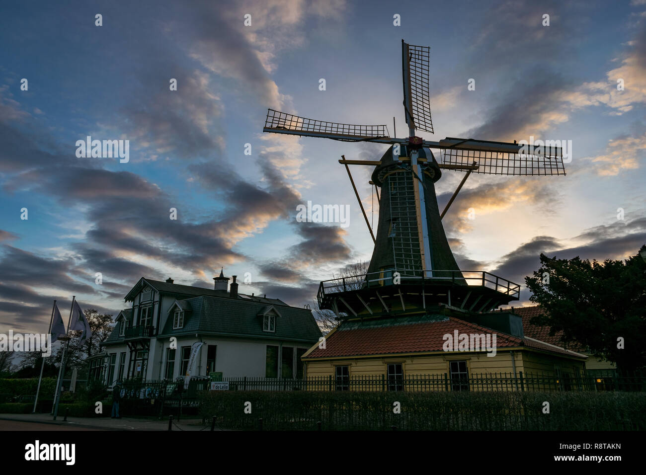 Dutch windmill near Lake `Kralingse Plas` in Rotterdam, The Netherlands. Historic buildings against a beautiful evening sky. Stock Photo